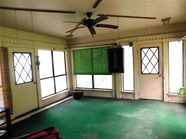 unfurnished sunroom with a wealth of natural light and ceiling fan