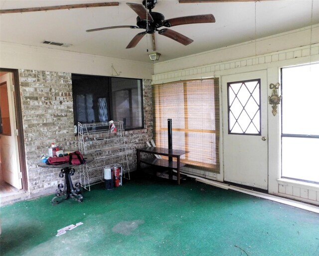 interior space with carpet floors and ceiling fan