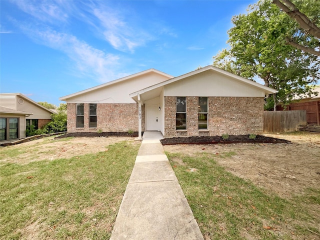 ranch-style home featuring a front yard