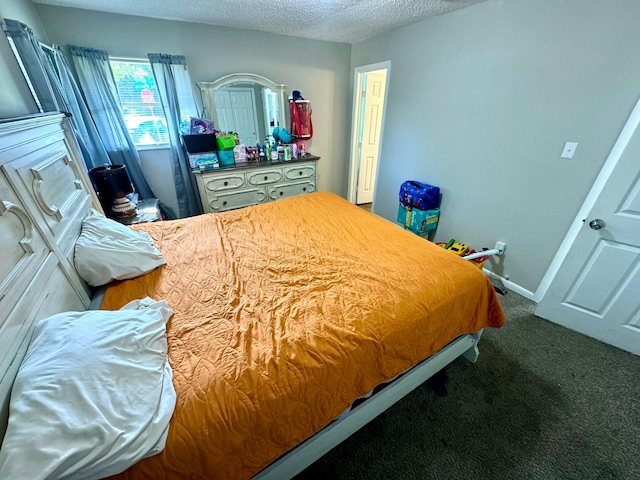 bedroom with baseboards, a textured ceiling, and carpet flooring