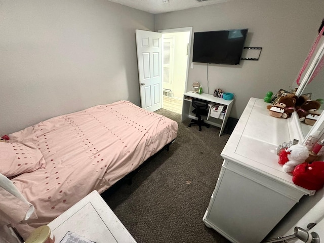 bedroom with dark colored carpet