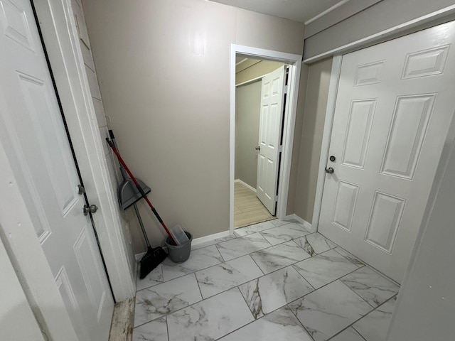 interior space with marble finish floor and baseboards