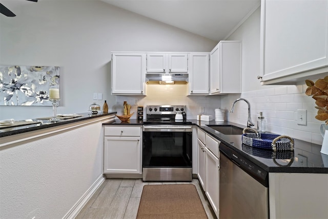 kitchen with decorative backsplash, stainless steel appliances, sink, white cabinetry, and lofted ceiling