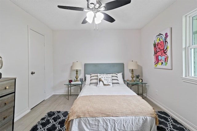 bedroom with ceiling fan and light wood-type flooring