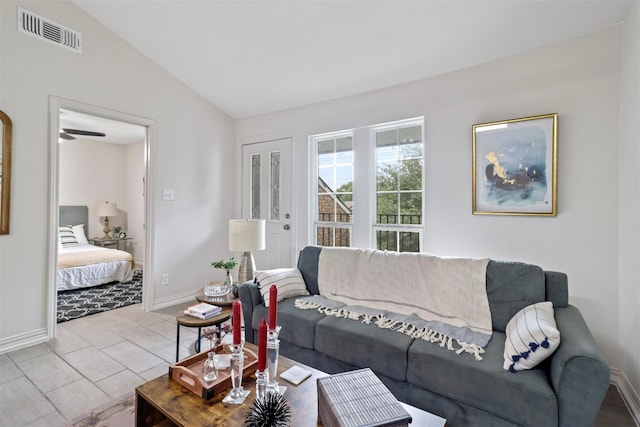 living room with ceiling fan and vaulted ceiling