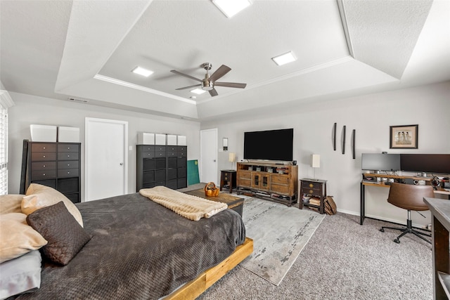 carpeted bedroom featuring ceiling fan, ornamental molding, and a raised ceiling