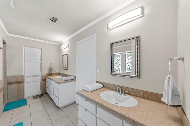 bathroom with tile walls, vanity, tile patterned floors, and ornamental molding