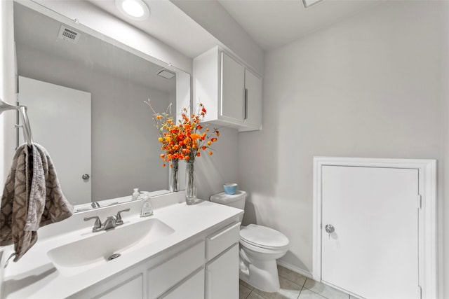 bathroom featuring toilet, vanity, and tile patterned flooring