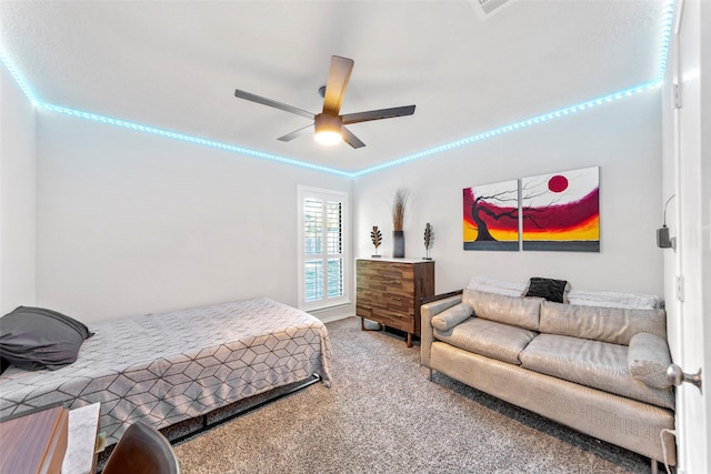 carpeted bedroom with ornamental molding and ceiling fan