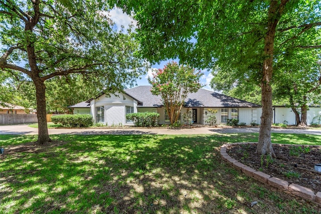 ranch-style house with a front lawn