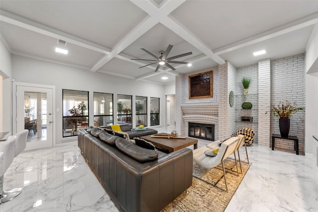 living room with a brick fireplace, beam ceiling, ceiling fan, and coffered ceiling