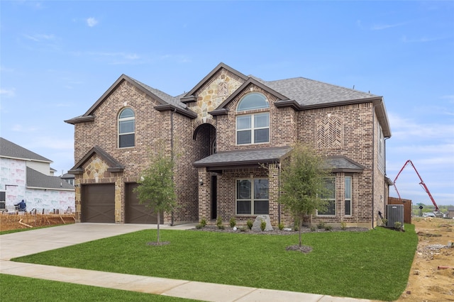 view of front of property featuring a garage and a front lawn