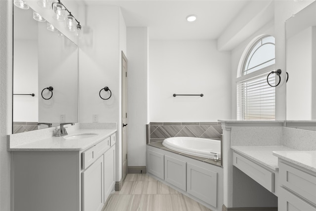 bathroom featuring vanity and a bath