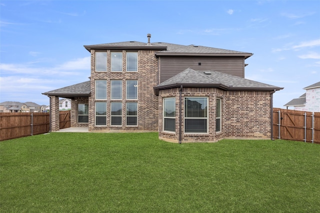 back of property featuring a lawn and a patio area