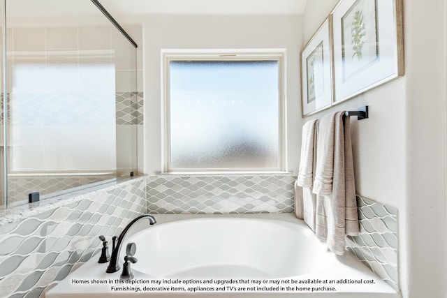 bathroom featuring a tub to relax in