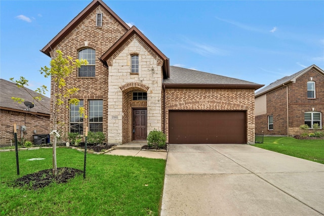 view of front of home with a front lawn and a garage