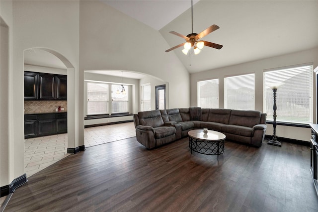 living room with hardwood / wood-style floors, ceiling fan, vaulted ceiling, and a baseboard radiator