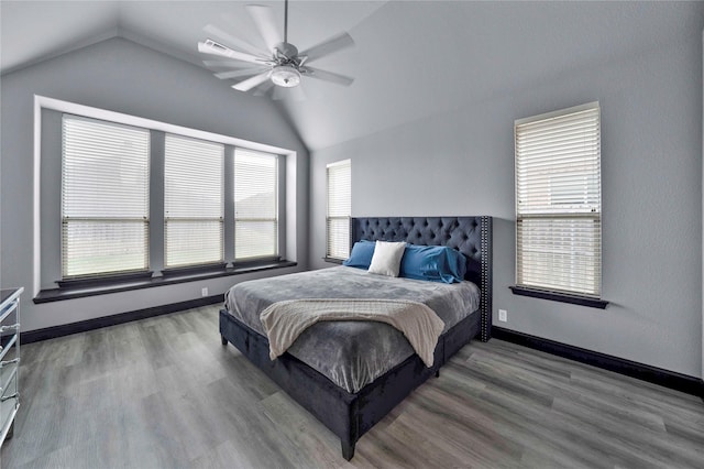 bedroom with ceiling fan, wood-type flooring, and lofted ceiling