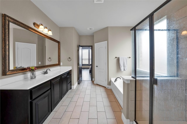 bathroom with tile patterned floors, vanity, and plus walk in shower