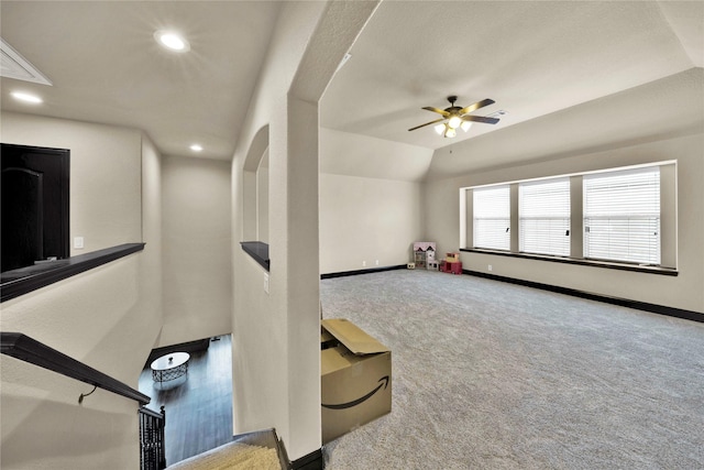 interior space featuring ceiling fan, carpet, and vaulted ceiling