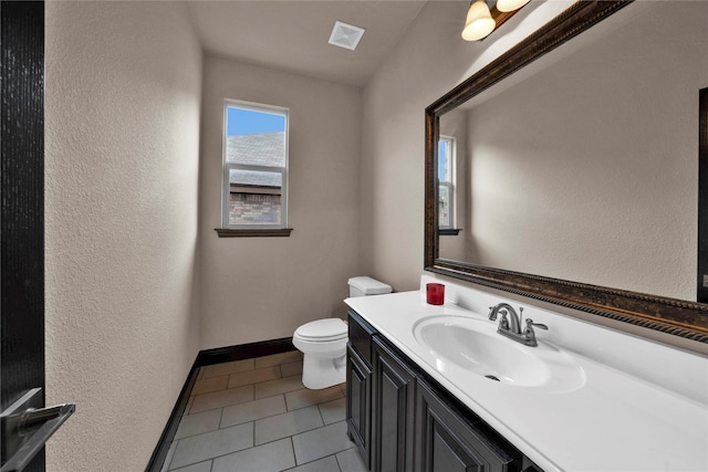 bathroom with tile patterned floors, vanity, and toilet