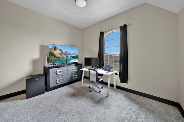 office space with light carpet and vaulted ceiling