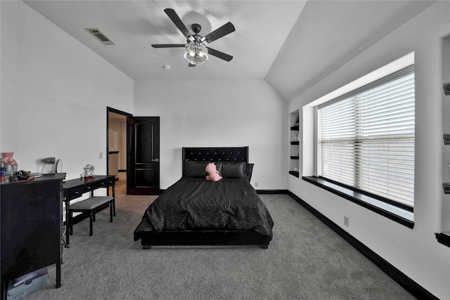 carpeted bedroom with ceiling fan and vaulted ceiling