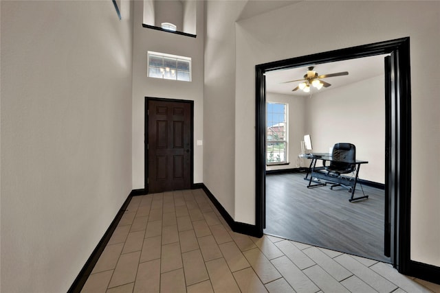 foyer entrance with ceiling fan and light hardwood / wood-style flooring