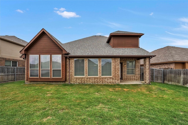 back of house with a lawn and a patio