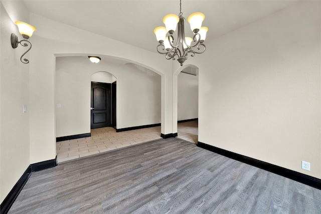 unfurnished dining area featuring light tile patterned flooring and an inviting chandelier