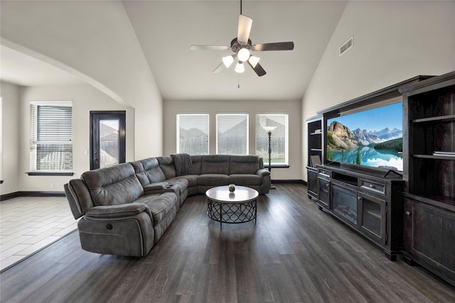 living room with dark hardwood / wood-style floors, ceiling fan, and high vaulted ceiling