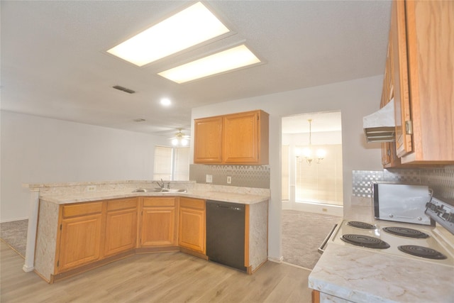 kitchen with sink, ventilation hood, light wood-type flooring, black dishwasher, and kitchen peninsula