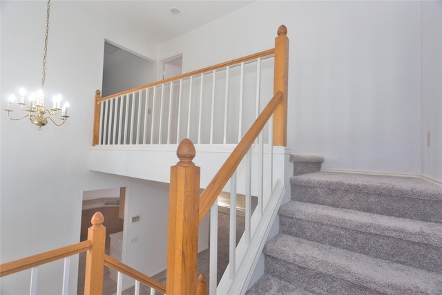 stairway with a chandelier