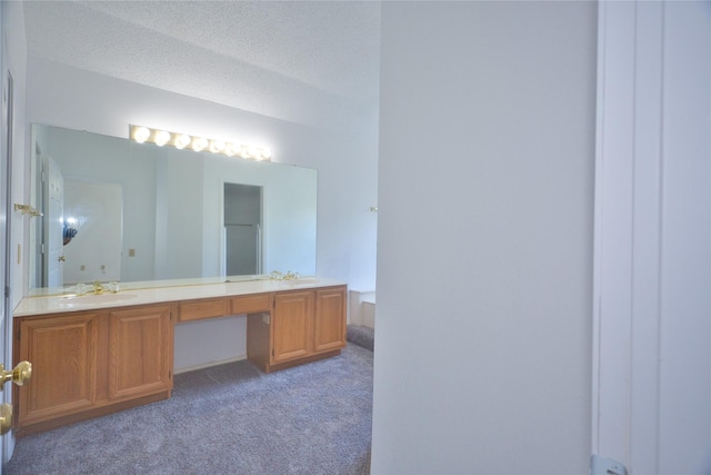 bathroom with vanity and a textured ceiling