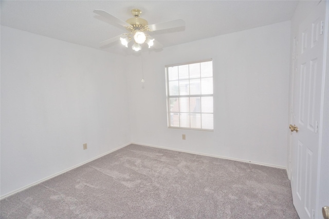 empty room with light colored carpet and ceiling fan