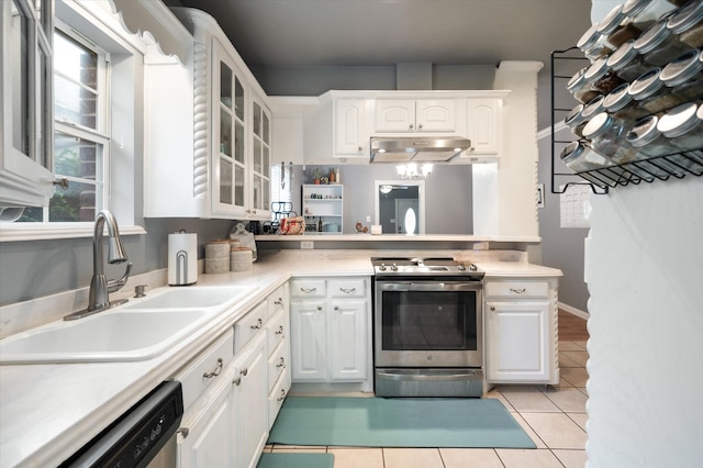 kitchen featuring white cabinetry, light tile patterned floors, stainless steel range oven, extractor fan, and sink