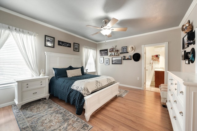 bedroom featuring light hardwood / wood-style flooring, connected bathroom, ceiling fan, and crown molding