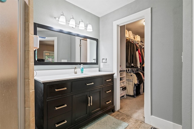 bathroom with hardwood / wood-style floors and vanity