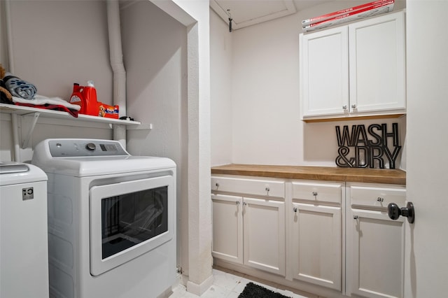 laundry area featuring cabinets and washing machine and dryer