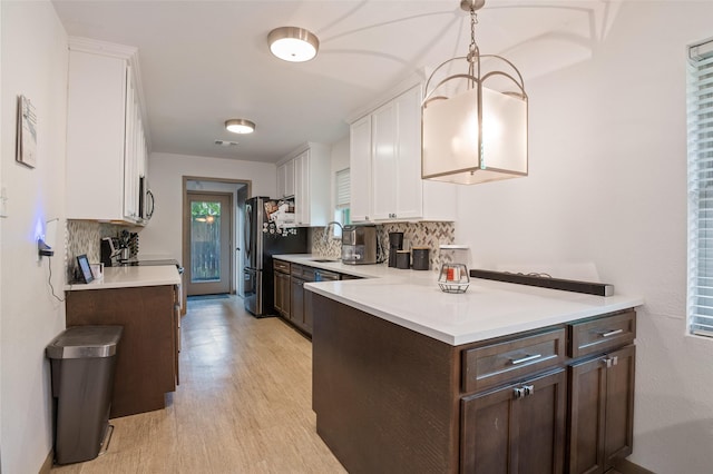 kitchen featuring white cabinetry, dark brown cabinetry, and tasteful backsplash