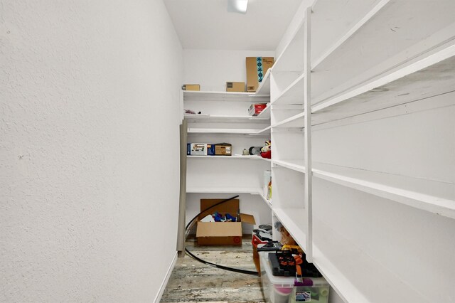 clothes washing area with ceiling fan, separate washer and dryer, and hardwood / wood-style flooring