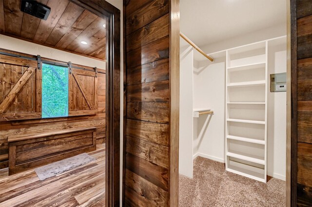 bathroom with wood-type flooring, wood ceiling, wood walls, and vanity