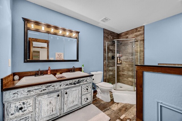 full bathroom with wood-type flooring, toilet, vanity, and shower with separate bathtub