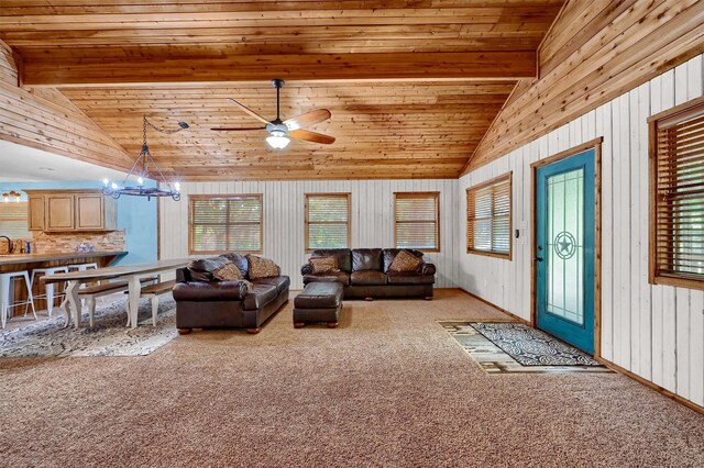 living room with light colored carpet, wooden walls, wood ceiling, high vaulted ceiling, and ceiling fan with notable chandelier