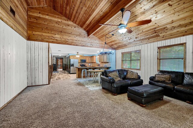 living room featuring wood walls, high vaulted ceiling, light carpet, ceiling fan with notable chandelier, and wooden ceiling