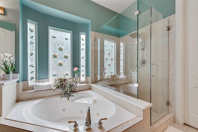 bathroom featuring separate shower and tub