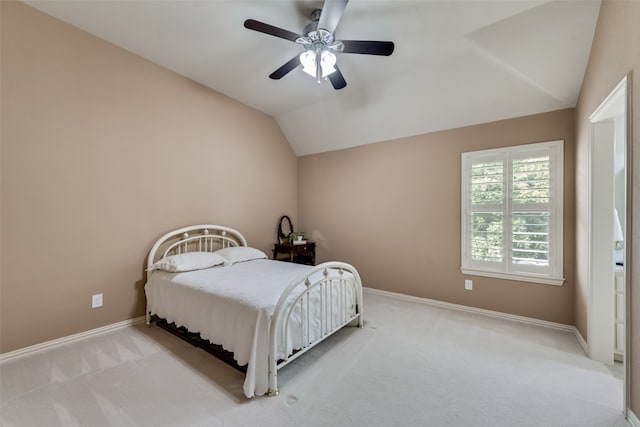 bedroom featuring ceiling fan, lofted ceiling, and light carpet