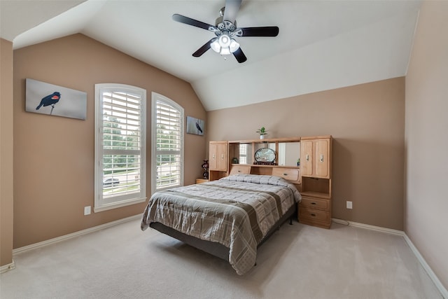 carpeted bedroom with ceiling fan and lofted ceiling