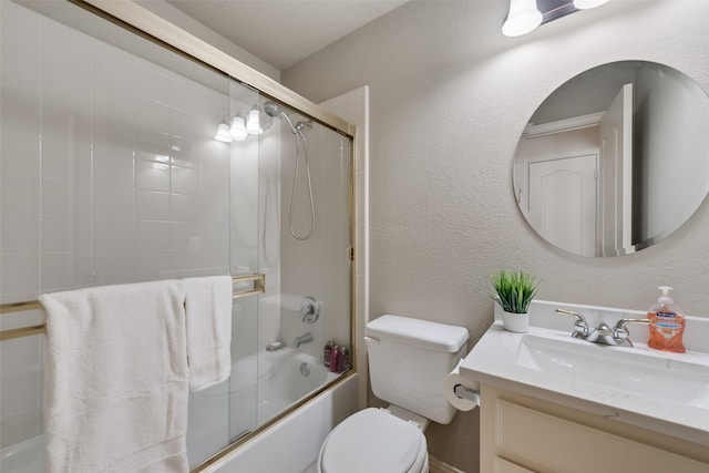 full bathroom featuring vanity, toilet, and combined bath / shower with glass door