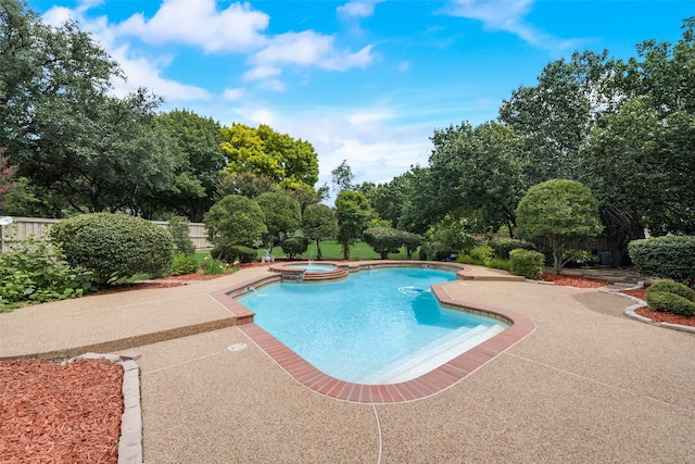 view of pool featuring a patio area and an in ground hot tub